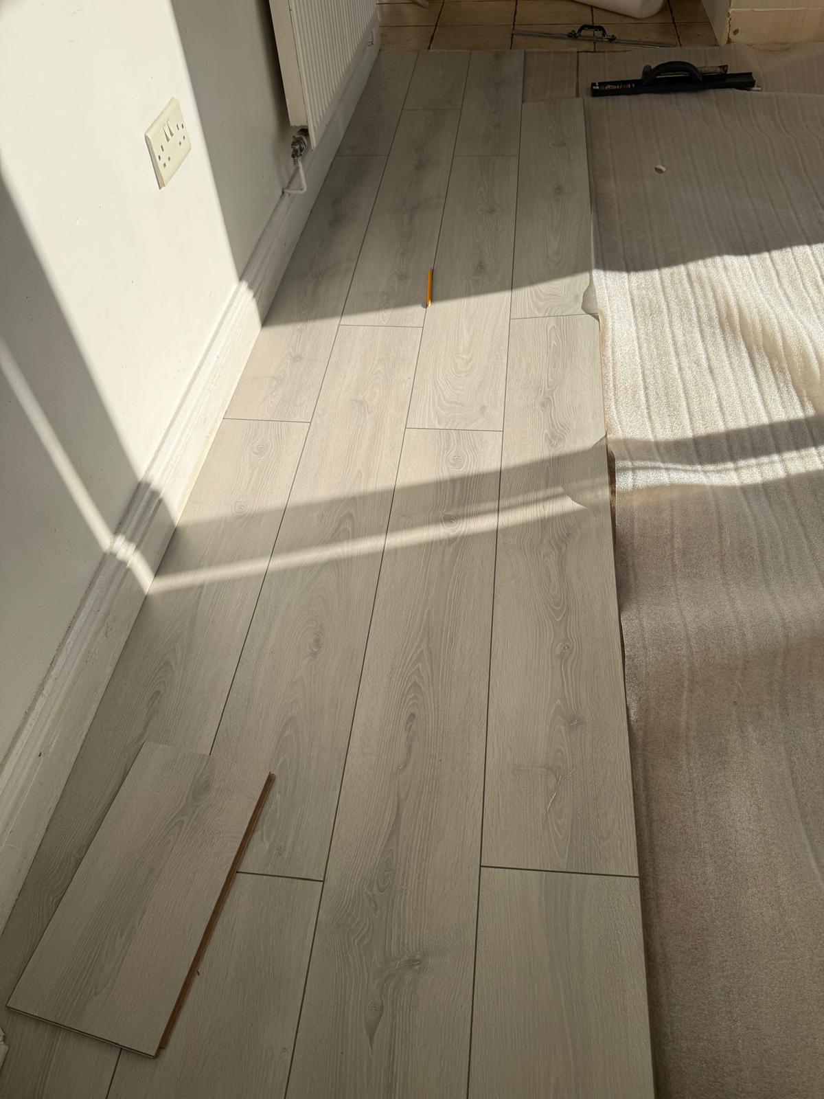 Laminate boards cut in tight to the skirting under a radiator